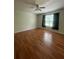 Cozy bedroom featuring wood-look floors, ceiling fan, and ample natural light at 14104 Fairington Circle Ridge, Stonecrest, GA 30038