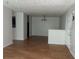 Open-concept living space with wood-look floors, neutral walls, and a view into the kitchen at 14104 Fairington Circle Ridge, Stonecrest, GA 30038