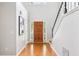 Bright foyer with hardwood floors, a wooden front door, and a staircase with black railings at 3405 Glenrose Trail Trl, Atlanta, GA 30341