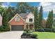 Beautiful home featuring a well-maintained lawn, mature trees, and a brick and siding facade at 3405 Glenrose Trail Trl, Atlanta, GA 30341