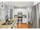 Well-lit kitchen features stainless steel appliances, granite countertops, and hardwood floors at 3405 Glenrose Trail Trl, Atlanta, GA 30341
