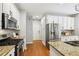 Bright kitchen boasts stainless steel appliances, granite countertops, and white cabinets at 3405 Glenrose Trail Trl, Atlanta, GA 30341
