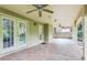 Covered patio with tile flooring and ceiling fans near the manicured backyard with mature trees at 3405 Glenrose Trail Trl, Atlanta, GA 30341