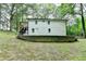 Back exterior view of a two-story house with a lawn and retaining wall at 737 Bolton Nw Rd, Atlanta, GA 30331