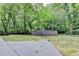 Overgrown wooded backyard and a partial view of a shed and a cement terrace at 737 Bolton Nw Rd, Atlanta, GA 30331
