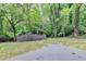 Overgrown wooded backyard and a partial view of a shed and a cement terrace at 737 Bolton Nw Rd, Atlanta, GA 30331