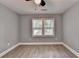 Bedroom featuring two windows, wood-look flooring and neutral-colored walls at 737 Bolton Nw Rd, Atlanta, GA 30331