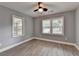 Well-lit bedroom features two windows and wood-look flooring at 737 Bolton Nw Rd, Atlanta, GA 30331