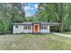 Charming renovated home with an orange front door, cedar shutters, and a covered carport at 737 Bolton Nw Rd, Atlanta, GA 30331