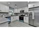 Bright kitchen boasts white cabinetry, stainless appliances, and sleek gray countertops at 737 Bolton Nw Rd, Atlanta, GA 30331
