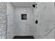 White marble tiled shower with black accents and modern fixtures at 737 Bolton Nw Rd, Atlanta, GA 30331