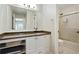 Bright bathroom features granite countertops, updated shower, and plenty of natural light at 3210 Lake Pointe Cir, Roswell, GA 30075