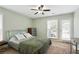 Bright bedroom featuring a ceiling fan, windows with blinds, and an outdoor access door at 3210 Lake Pointe Cir, Roswell, GA 30075