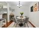 Charming dining area with a view of the kitchen featuring cherrywood floors and seating for four at 3210 Lake Pointe Cir, Roswell, GA 30075