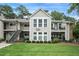 Inviting condo featuring well-maintained landscaping, a combination of siding and stone, and a large front lawn at 3210 Lake Pointe Cir, Roswell, GA 30075