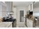 Updated kitchen with stainless steel appliances and mosaic tile backsplash at 3210 Lake Pointe Cir, Roswell, GA 30075