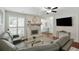 Comfortable living room with a stone fireplace, cherrywood floors, and large windows with plantation shutters at 3210 Lake Pointe Cir, Roswell, GA 30075