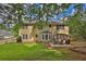 View of backyard showcasing patio area with seating, and lush lawn at 1254 Williston Dr, Lawrenceville, GA 30044