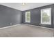 Bedroom with two large windows, gray carpet, and gray walls at 1254 Williston Dr, Lawrenceville, GA 30044