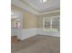Dining room featuring wainscoting, neutral walls, carpeting, and a view to the backyard at 1254 Williston Dr, Lawrenceville, GA 30044
