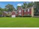 This two-story brick home boasts a lush green lawn, well-maintained landscaping, and a two-car garage at 1254 Williston Dr, Lawrenceville, GA 30044