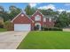 Beautiful two-story brick home featuring a well-manicured lawn and attached two-car garage at 1254 Williston Dr, Lawrenceville, GA 30044