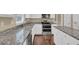 Bright kitchen features granite countertops, stainless steel appliances, white cabinets, and hardwood floors at 1254 Williston Dr, Lawrenceville, GA 30044