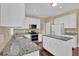Kitchen with white cabinets, granite counters, stainless steel appliances, and a central island at 1254 Williston Dr, Lawrenceville, GA 30044