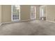Bright living room with neutral walls, carpeting, and ample natural light from large windows at 1254 Williston Dr, Lawrenceville, GA 30044