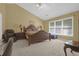 Main bedroom with large window, beige carpet, and an ensuite bathroom at 1254 Williston Dr, Lawrenceville, GA 30044
