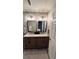Bathroom with dual sinks, modern fixtures, wood-look flooring and a decorative rug at 2443 Abner Nw Pl, Atlanta, GA 30318