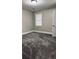 Cozy bedroom with neutral walls, plush gray carpet, and natural light from a window at 2443 Abner Nw Pl, Atlanta, GA 30318