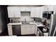 Stylish kitchen boasts white cabinetry, stainless steel appliances, granite counters, and subway tile backsplash at 2443 Abner Nw Pl, Atlanta, GA 30318