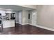 Spacious living area features sleek hardwood floors and ample natural light, seamlessly flowing into the modern kitchen at 2443 Abner Nw Pl, Atlanta, GA 30318