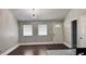 Bright living room featuring hardwood floors, two windows, neutral walls, and a modern light fixture at 2443 Abner Nw Pl, Atlanta, GA 30318