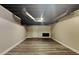 Unfinished basement has plank flooring, painted walls, and painted ceiling at 247 Millbrook Farm Rd, Marietta, GA 30068
