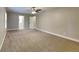 Primary bedroom with neutral colored walls, carpet flooring, ceiling fan, and bathroom access at 247 Millbrook Farm Rd, Marietta, GA 30068