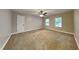 Large bedroom has neutral colored walls, carpet flooring, and two windows at 247 Millbrook Farm Rd, Marietta, GA 30068