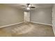 Bedroom features neutral colored walls, carpet flooring, ceiling fan, and attached bathroom at 247 Millbrook Farm Rd, Marietta, GA 30068