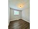 A well-lit bedroom features wood-look floors and a neutral color palette at 3544 Citrus Dr, Duluth, GA 30096