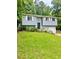Charming home featuring a well-manicured lawn, light blue siding, and white garage door at 3544 Citrus Dr, Duluth, GA 30096