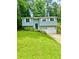 Charming home featuring a well-manicured lawn, light blue siding, and white garage door at 3544 Citrus Dr, Duluth, GA 30096