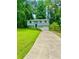 Home with a driveway, manicured lawn, and mature trees at 3544 Citrus Dr, Duluth, GA 30096