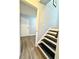 Hallway leading to stairs and a room with vinyl floors and neutral paint at 3544 Citrus Dr, Duluth, GA 30096