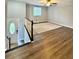 Spacious living room with hardwood floors, neutral walls, and an open staircase at 3544 Citrus Dr, Duluth, GA 30096