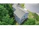 Aerial view of a gray home surrounded by green trees, showcasing its layout and position in the landscape at 1630 Eaglerock Dr, Suwanee, GA 30024