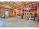 Unfinished basement framed with wood, showing exposed insulation, concrete floors, and a door at 1630 Eaglerock Dr, Suwanee, GA 30024
