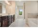 Modern bathroom featuring a double vanity, dark cabinets, and a shower/tub combo at 1630 Eaglerock Dr, Suwanee, GA 30024