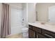 Bathroom with tub and shower combination and elegant vanity at 1630 Eaglerock Dr, Suwanee, GA 30024