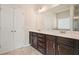 Modern bathroom featuring a double vanity, dark cabinets, and a large mirror with great lighting at 1630 Eaglerock Dr, Suwanee, GA 30024